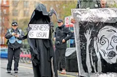  ?? ?? Activists take part in a demonstrat­ion in London. (Photo by HENRY NICHOLLS / AFP)