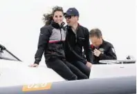  ??  ?? Wills and Kate follow the racing on a power boat