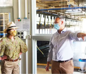  ??  ?? Agricultur­e Minister Mary-Anne Thomas tours the dairy alongside research director Joe Jacobs after officially opening “Ellinbank SmartFarm” on Wednesday.