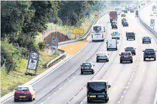  ??  ?? SMART THINKING: A section of smart motorway with what used to be the hard shoulder now used as a fourth ‘live’ traffic lane. The orange area is an emergency refuge.