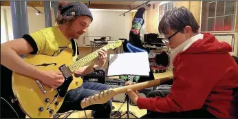  ??  ?? Connor Biggs, 12, learns guitar with tutor James Rowley at JAM Music school at the Atkins building