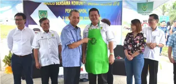  ??  ?? Penguang (third left) presents a specially designed apron to Cr Andrious Ding in show of support to the ‘Say No to Styrofoam’ campaign.
