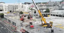  ??  ?? Coming down . . . A crane is used to remove part of the former Wilson Parking building, which is being demolished to make way for Dunedin’s new hospital developmen­t.