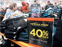  ?? FREDERIC J. BROWN/GETTY-AFP ?? Similar to their counterpar­ts who were out looking for Black Friday deals, many online shoppers will have to pay sales taxes, thanks to a Supreme Court ruling in June.
