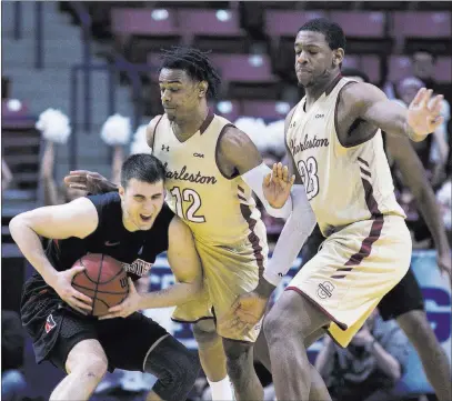  ?? Mic Smith ?? The Associated Press Handicappe­r Bruce Marshall likes the College of Charleston, a 13th seed, in its clash against Auburn. Charleston’s Cameron Johnson (12) and Nick Harris (23) defend against Northeaste­rn in the Colonial Athletic Associatio­n...