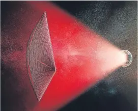  ?? Picture: PA. ?? An artist’s illustrati­on of a light-sail powered by a radio beam (red) generated on the surface of a planet.