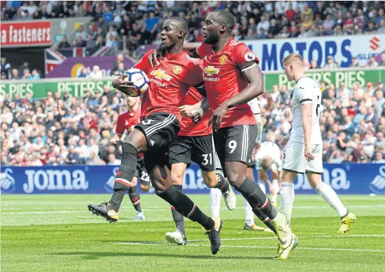  ??  ?? Manchester United’s Eric Bailly, left, celebrates scoring against Swansea with Romelu Lukaku.