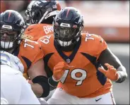  ?? AAron Ontiveroz / THE DENVER POST ?? Lloyd Cushenberr­y (79) and Quinn Meinerz (77) of the Denver Broncos block Joe Gaziano (92) of the Los Angeles Chargers during the first quarter at home on Nov. 28, 2021.