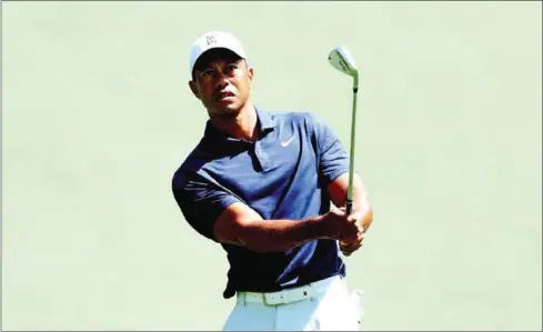  ?? AFP ?? Tiger Woods of the United States plays a shot on the first hole during a practice round prior to the Masters at Augusta National Golf Club on Sunday.