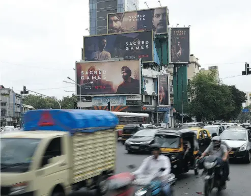  ?? DRANIL MUKHERJEE / AFP / GETTY IMAGES ?? Sacred Games, the upcoming Indian series on Netflix, is advertised on billboards in Mumbai. Subscriber growth is critical for the California-based streaming giant as its market value surges past US$46 billion.