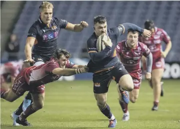  ??  ?? 0 Edinburgh’s Matt Scott breaks away from Scarlets’ Dan Jones at BT Murrayfiel­d.