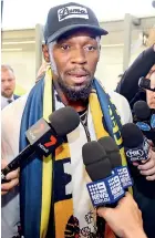  ??  ?? Usain Bolt talks to the media upon arrival at Sydney internatio­nal airport. Bolt, 31-year-old eight-time Olympic champion, arrived to start training with the A-League club Central Coast Mariners - AFP