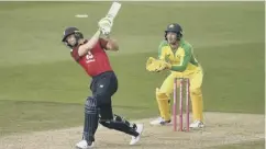  ??  ?? 0 England’s Jos Buttler hits a six to seal victory over Australia.