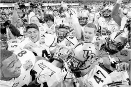  ?? KEVIN C. COX/GETTY ?? UCF's win over Auburn in the January 2018 Peach Bowl remains one of the milestone American Athletic Conference victories.