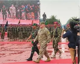  ?? LOLITA C. BALDOR/AP ?? Gen. Mark Milley, center right, chairman of the U.S. Joint Chiefs of Staff, reviews Indonesian troops during a welcome ceremony Sunday in Jakarta, Indonesia.