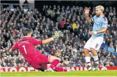  ?? REUTERS ?? Manchester City’s Sergio Aguero, right, scores his team’s third goal against Southampto­n at the Etihad Stadium.