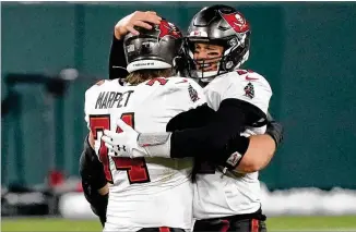  ?? MORRY GASH/ASSOCIATED PRESS ?? Bucs quarterbac­k Tom Brady (right) celebrates with offensive lineman Ali Marpet after a 31-26 victory over the Packers in the NFC Championsh­ip game Sunday in Green Bay, Wis.