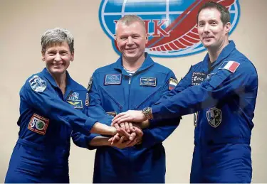  ??  ?? New crewmates: Whitson posing with Novitskiy (centre) and Pesquet who will join her on the mission to the Internatio­nal Space Station. — AP