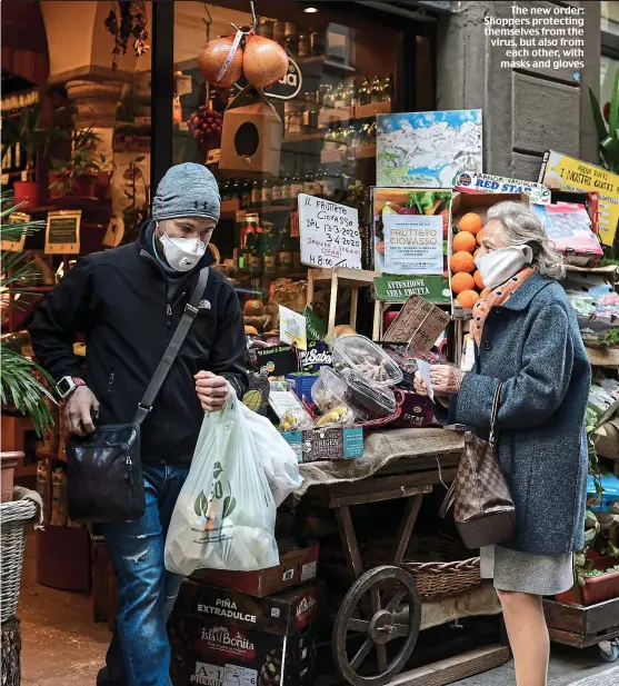  ??  ?? The new order: Shoppers protecting themselves from the virus, but also from each other, with masks and gloves