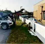  ?? BROCKTON FIRE DEPARTMENT ?? A tow truck was used to remove a car dangling near a Chick-fil-A restaurant in Brockton Sept. 28.