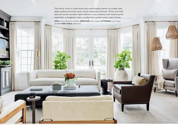  ??  ?? The family room is clean-lined and comfortabl­e thanks to a sleek sofa, deep-seated armchairs and a plush oversized ottoman. Off to one side, textural woven pendant lights define a cozy reading nook featuring the essentials: a wingback chair, a cushy...