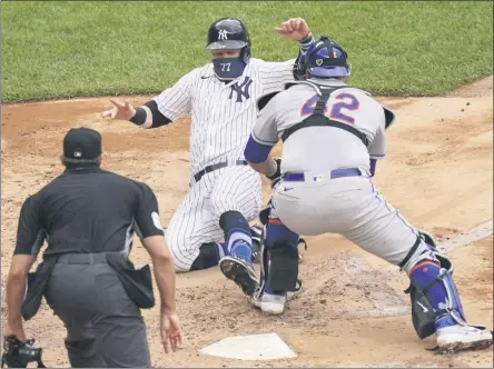  ?? JOHN MINCHILLO - THE ASSOCIATED PRESS ?? New York Yankees’ Clint Frazier (77) is tagged out at home by New York Mets catcher Wilson Ramos, right, in the fourth inning of a baseball game, Saturday, Aug. 29, 2020, in New York.