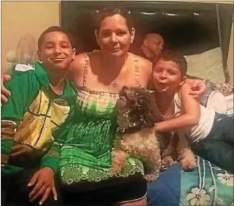  ??  ?? Lillian Duran, middle, and sons Christian, left, and Kevin embrace in happier times. Duran’s body was found in a plastic bag. Her family suspects foul play.