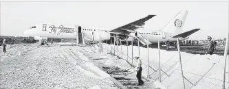  ?? ADRIAN NARINE THE ASSOCIATED PRESS ?? A Fly Jamaica Boeing 757-200 aircraft, which overshot the runway, sits at the northeaste­rn takeoff end of the runway at the Cheddi Jagan Internatio­nal Airport in Georgetown, Guyana, Friday.