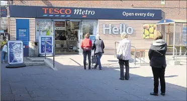  ?? Picture: Chris Davey ?? People queuing outside Tesco in Rainham due to the social distancing rules brought in to deal with the coronaviru­s pandemic