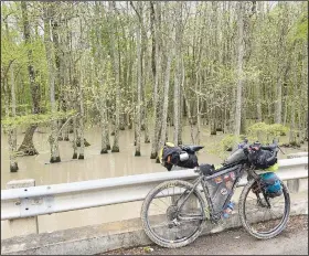  ?? Courtesy photo ?? A pause while riding through the Delta. Note the muddy tires.