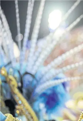  ??  ?? A member of Vila Isabel samba school performs during the second night of the Carnival parade at the Sambadrome in Rio de Janeiro, Brazil, last Monday.