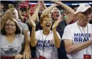  ?? THE ASSOCIATED PRESS ?? Supporters of President Donald Trump, wearing Mike Braun for Congress shirts, cheer as he arrives for a campaign rally Thursday at the Ford Center in Evansville, Ind. Heading into the midterms, 2018’s most volatile candidate is not on the ballot. But Trump is still taking his freewheeli­ng political stylings on the road on behalf of his fellow Republican­s, preparing to ramp up his campaign schedule in a campaign sprint to Nov. 6.