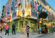  ?? KENNETH MAGUIRE/AP ?? A bagpiper plays in front of a Dublin bar Thursday as businesses welcome Navy and Notre Dame fans.