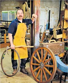  ?? ?? Gregory Rowland, a wheelwrigh­t whose family made wheels in 1331, received an MBE