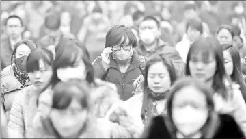  ?? – Reuters file photos ?? Beijing folk are seen on a street with facemasks.