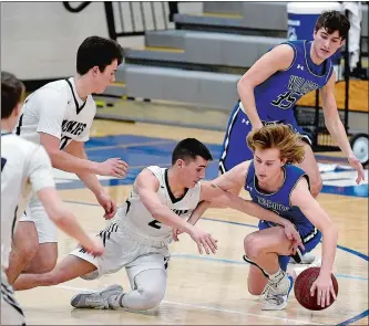  ?? SARAH GORDON/THE DAY ?? Old Lyme’s Brady Sheffield steals the ball from Morgan’s Jonathan Fiorillo (2) during Wednesday night’s game in Clinton. The Wildcats completed a perfect 16-0 Shoreline Conference regular-season with a 6750 victory over the Huskies. Visit theday.com to view a photo gallery.