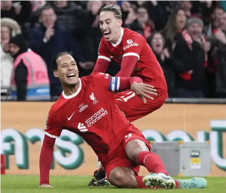  ?? AP ?? Liverpool’s Virgil van Dijk celebrates with Kostas Tsimikas after scoring his side’s winner against Chelsea in the League Cup final