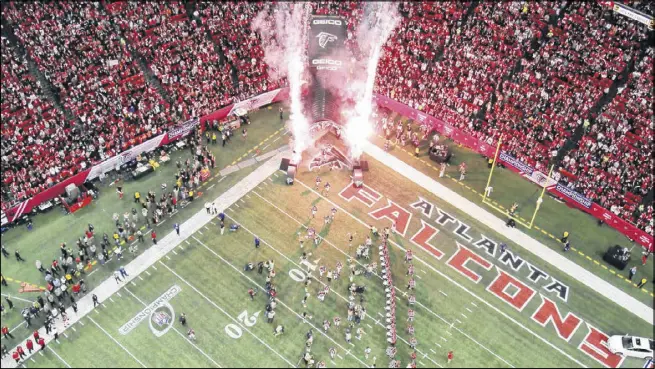  ?? JASON GETZ / JGETZ@AJC.COM ?? Atlanta Falcons players run out of the tunnel before their game against the San Francisco 49ers in the NFC Championsh­ip game at the Georgia Dome in January 2013. There’s a chance today will be the last time the Falcons run through that tunnel.