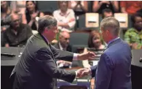  ?? GEORGE NETWORK-TENNESSEE ?? House Minority Leader Craig Fitzhugh, D-Ripley, and former Nashville Mayor Karl Dean, right, shake hands after the Tennessee Democratic gubernator­ial debate June 19 at Belmont University in Nashville. WALKER IV / USA TODAY