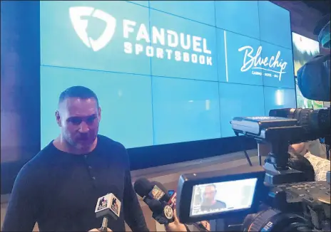  ?? JERRY DAVICH/POST-TRIBUNE PHOTOS ?? Chicago Bears legend Brian Urlacher talks with the media Thursday at the new FanDuel Sportsbook inside Blue Chip Casino in Michigan City, after placing the casino’s first sports wager.