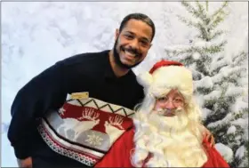  ??  ?? Rodney Anderson, of the UPS Store, visits with Santa.