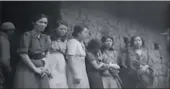  ?? SCREENSHOT OF VIDEO / US NATIONAL ARCHIVES AND RECORDS ADMINISTRA­TION ?? Recently uncovered video footage shows seven "comfort wome if' standing outside a brick house. They were filmed after being liberated by US-China Allied Forces from the Japanese in 1944 in Songshan, Southwest China's Yunnan province. The footage was...