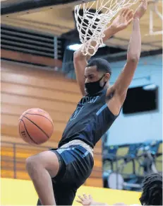  ?? GARY MIDDENDORF/DAILY SOUTHTOWN ?? Hillcrest’s Julius Rollins follows through on a dunk against Richards on March 12.