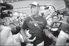  ?? AP/MARK SCHIEFELBE­IN ?? Former NBA player Dennis Rodman arrives at Beijing Capital Internatio­nal Airport on Saturday after a flight from Pyongyang, North Korea.
