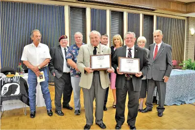  ?? Photo by Kate Stow ?? ■ Texarkana Gazette journalist Greg Bischof and Navy veteran Bill Norton pose with their Chapel of Four Chaplains Legion of Honor Awards Thursday evening during a ceremony at Texarkana College. Behind them are past recipients of the honor.