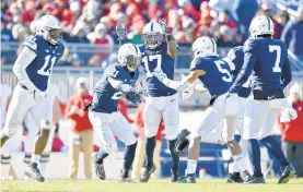  ?? ABBY DREY/CENTRE DAILY TIMES ?? Penn State cornerback Amani Oruwariye (21) celebrates an intercepti­on with fellow defensive players against Wisconsin.