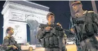  ?? THOMAS SAMSON/AFP ?? French soldiers stand guard at the Arc de Triomphe near the Champs Elysees in Paris after a shooting.