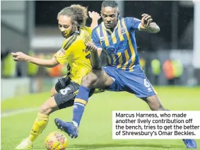  ??  ?? Marcus Harness, who made another lively contributi­on off the bench, tries to get the better of Shrewsbury’s Omar Beckles.