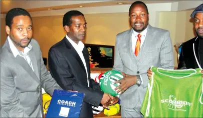  ??  ?? TOGETHER AS ONE ... CAPS United president Farai Jere (second from right) receives a ball from the Green Machine legend Joe Mugabe (second from left) in London on Monday as part of the consignmen­t donated by former Makepekepe players who are based in...