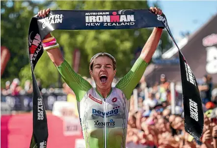  ?? PHOTOSPORT ?? Teresa Adam takes the Ironman NZ women’s race in Taupo yesterday.